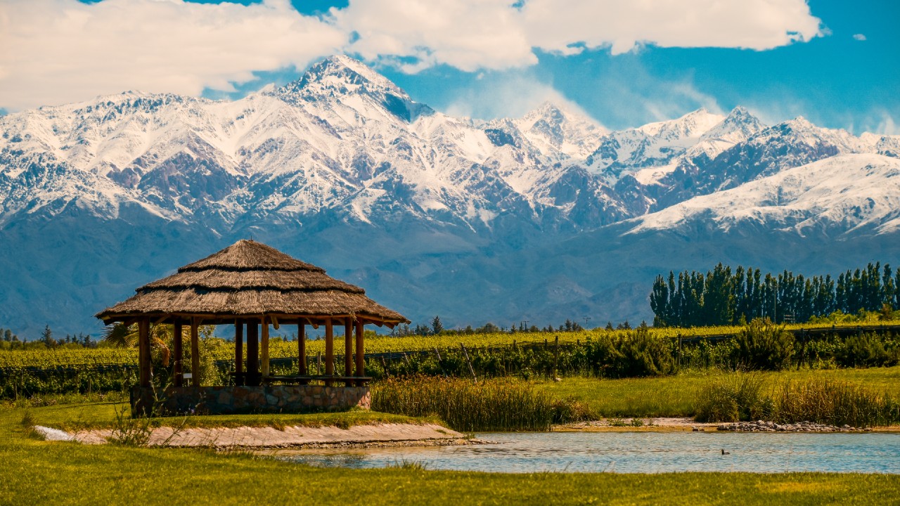 A thatched hut in front of mountains in Mendoza, Argentina
