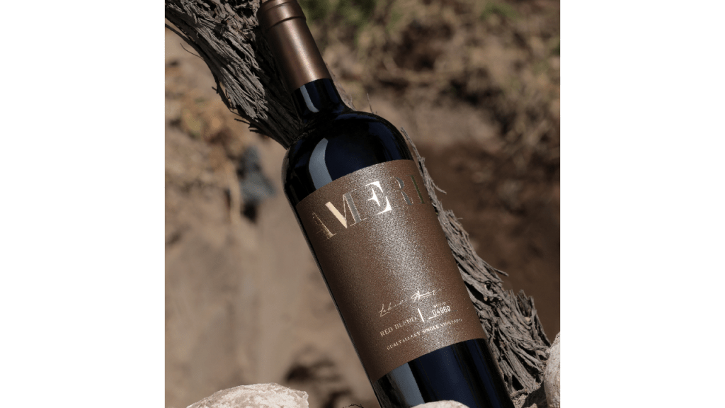 A bottle of Ameri red blend, one of Domaine Bousquet’s popular organic wines, lays against a tree branch